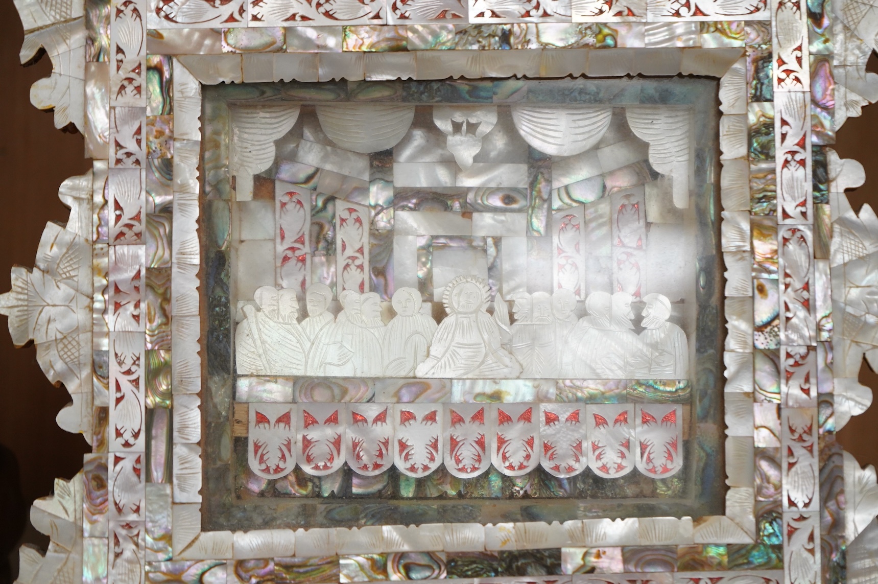 A mother of pearl carving and olivewood framed ‘The last supper’ panel, 30cm high
